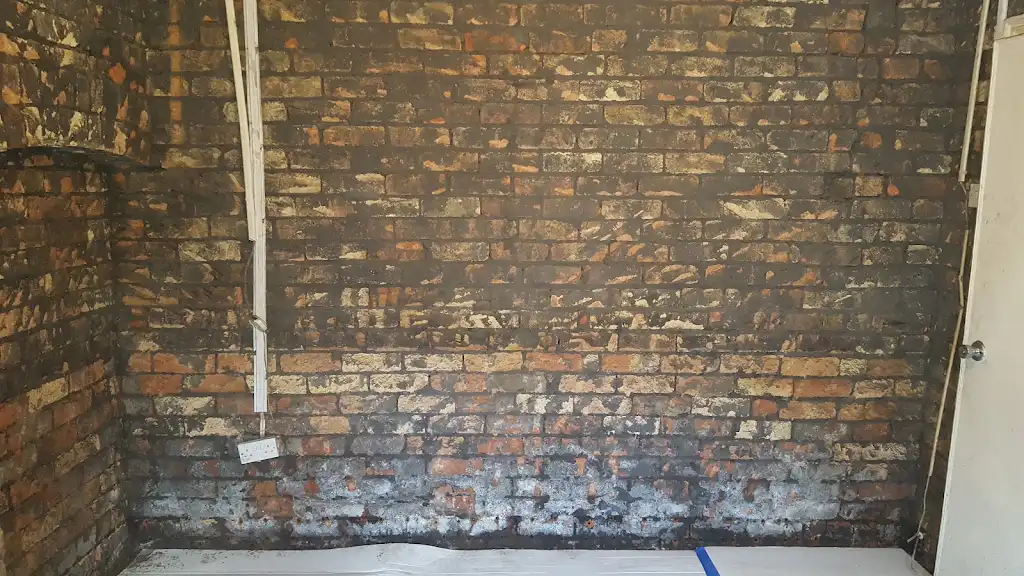 Brickwork exposed during damp proofing preparation
