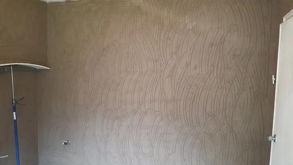 Prepared interior wall with fresh damp proofing render before final finish