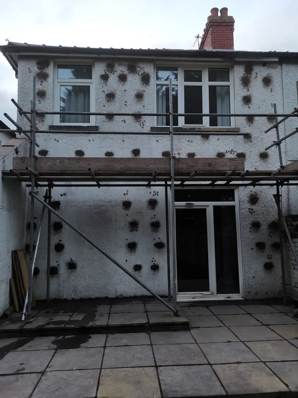 Rendered rear elevation with scaffold during cavity wall tie replacement