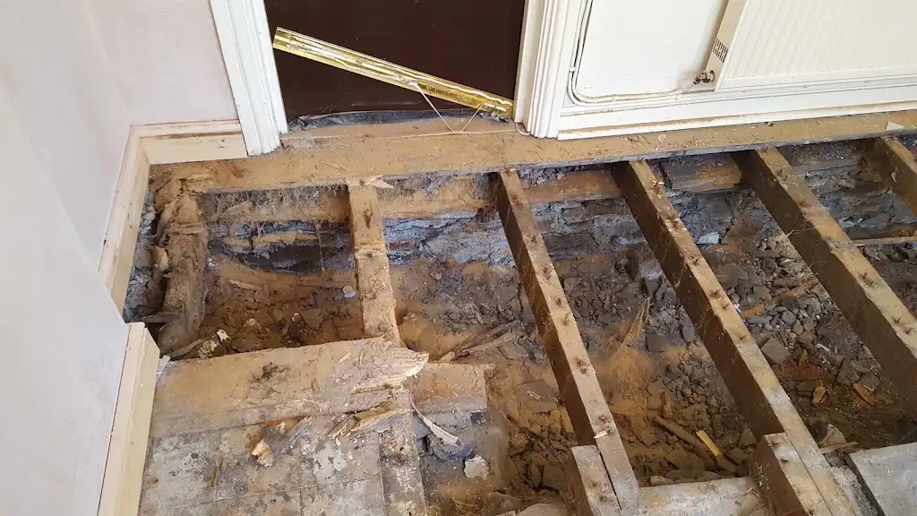 Floorboards lifted to inspect joists during woodworm treatment work